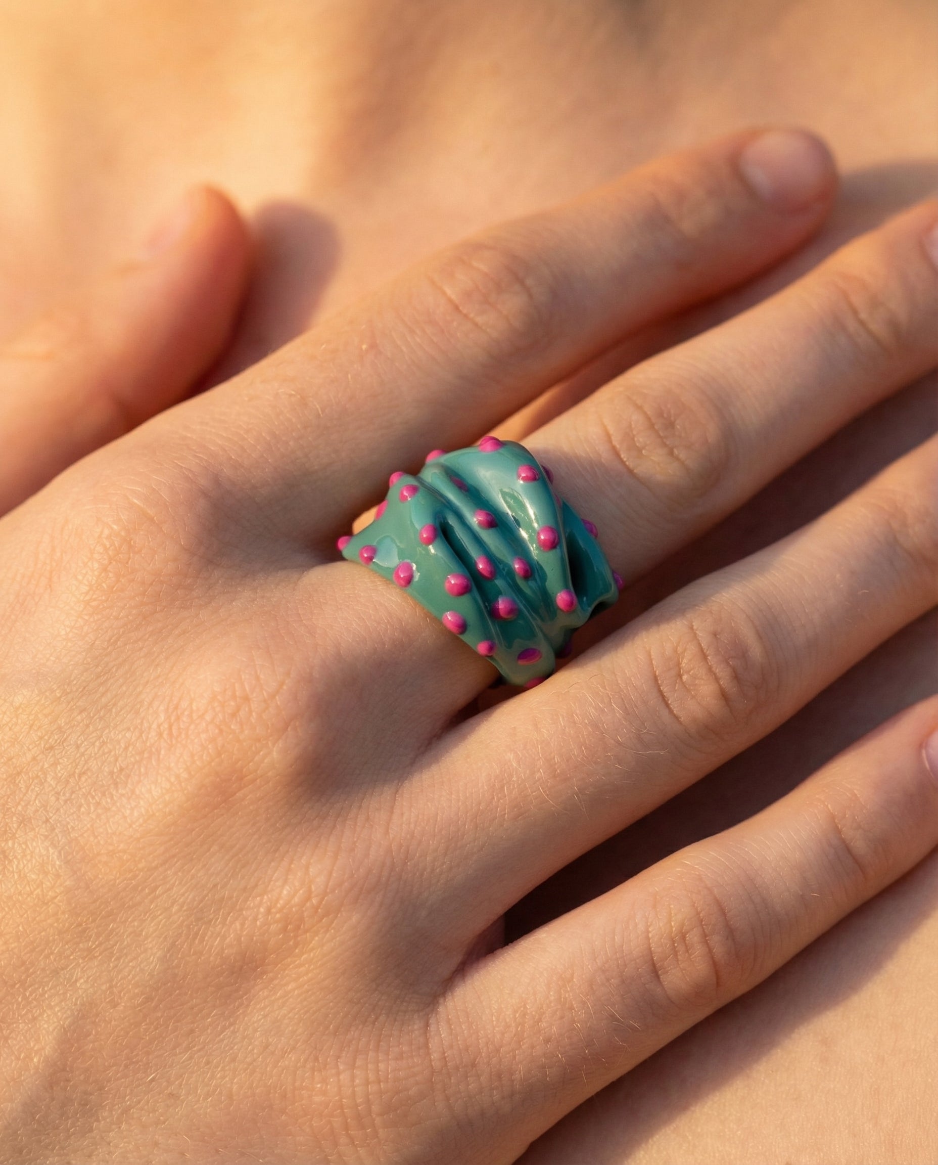 Efemera Wild Flower ring - teal enamel with pink dots on model