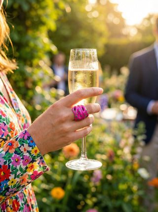 Efemera Draped in Time garden party - woman wearing Flora Mirage pink ring holding champagne